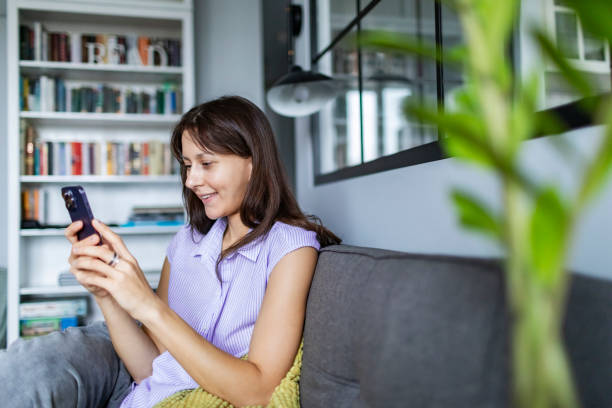 istock Young woman using mobile at home for online shopping 1763791349