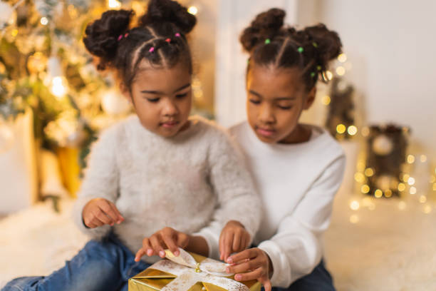 istock Girls unpacking Christmas presents 1763848405