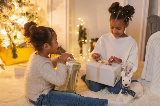 istock Girls unpacking Christmas presents 1763855927