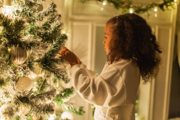 istock Little girl decorating Christmas tree 1763859736