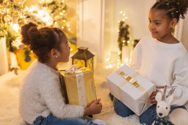 istock Girls unpacking Christmas presents 1763872190