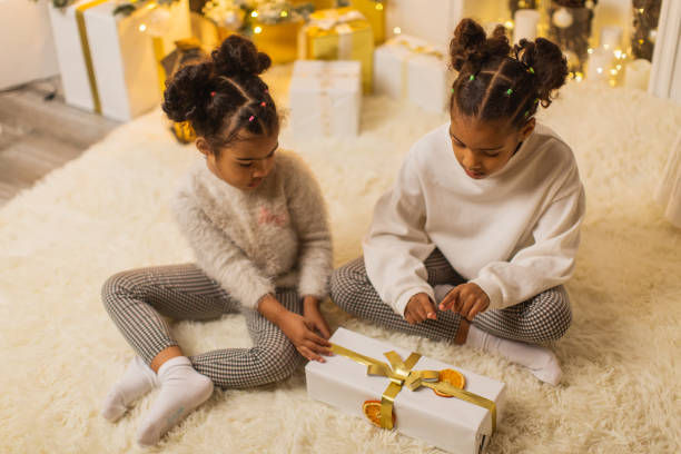 istock Girls unpacking Christmas presents 1763872869
