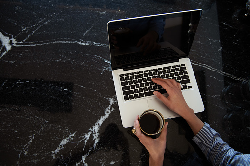 Freelancer workplace in kitchen with laptop