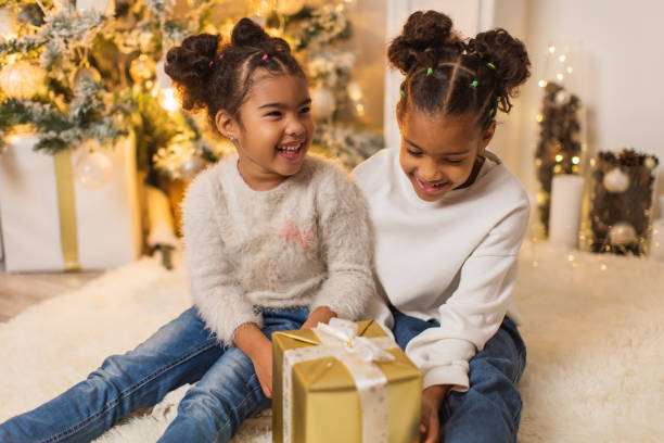 istock Girls unpacking Christmas presents 1763878637