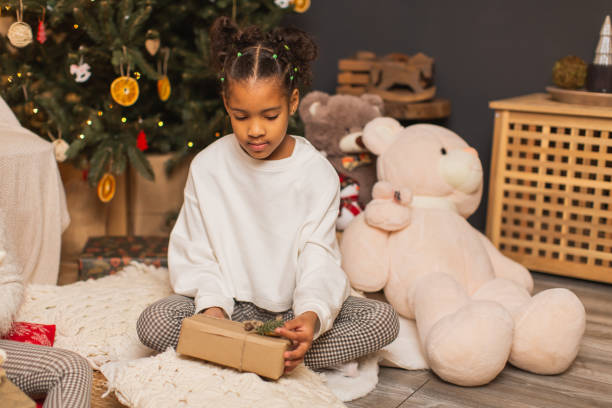 istock Little girl unpacking Christmas gift 1763880307