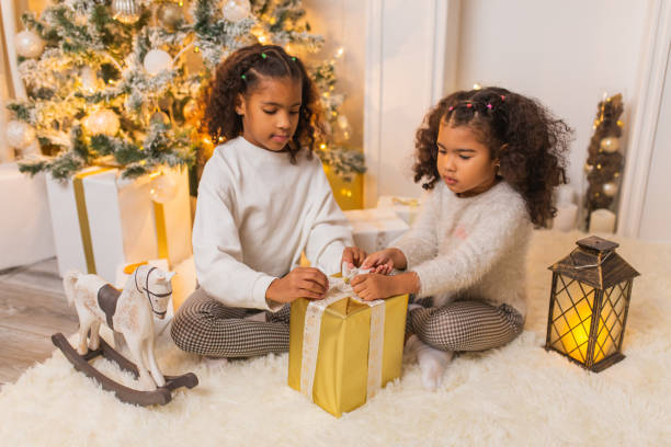 istock Girls unpacking Christmas presents 1763886558