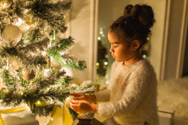 istock Little girl decorating Christmas tree 1763887909