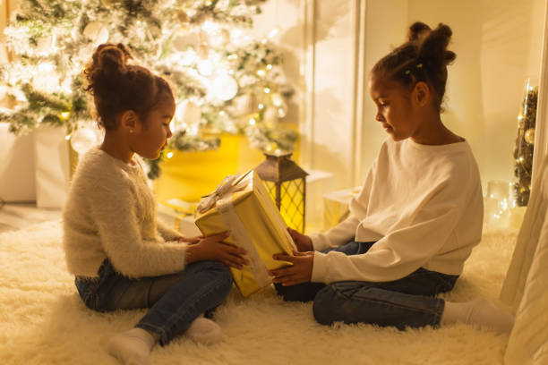 istock Girls unpacking Christmas presents 1763894710