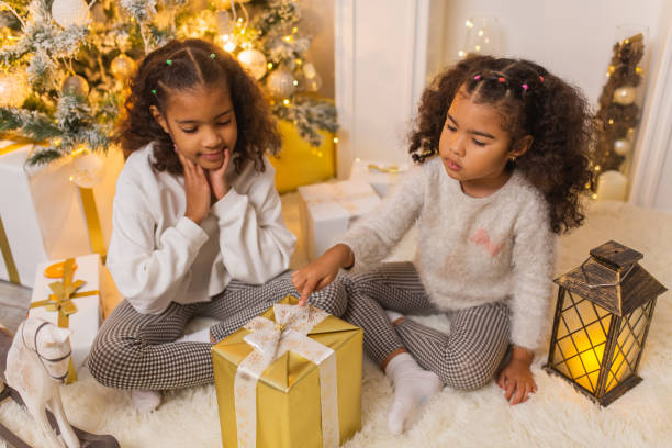 istock Girls unpacking Christmas presents 1763901776