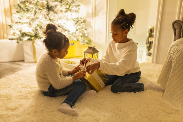 istock Girls unpacking Christmas presents 1763904005
