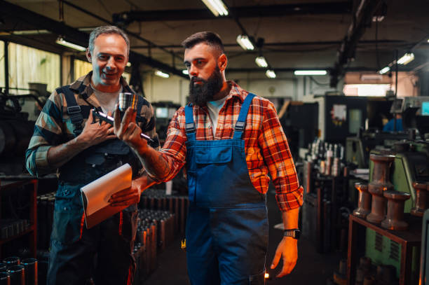 istock A factory worker holding a metal piece and discussing it with supervisor. 1763917108