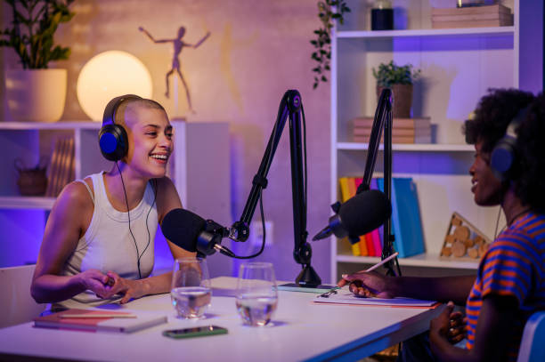 istock Two podcasters sitting in a home recording studio and making video content 1763917131