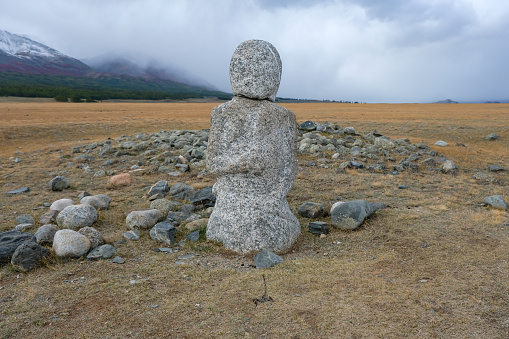 Balbal statue, marking a burial site, dating back 2,000 years in the Kazakh Bayan-Olgii Province of the Altai Mountains of Western Mongolia. The Turkic warrior human image carving, made from a single stone, stand out in remote areas of the mountains marking the graves of warrior ancestors.