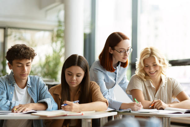 istock Young smiling teacher or tutor having lesson, assisting, explaining something. Education concept 1763926510