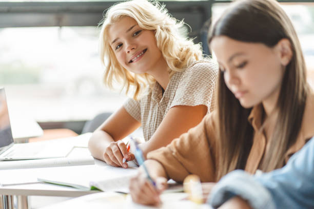 istock School girls studying together, learning language in classroom. Back to school, lesson, education 1763926516