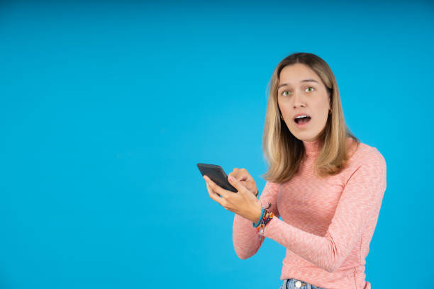 istock Young woman caught looking at her cell phone 1763980957