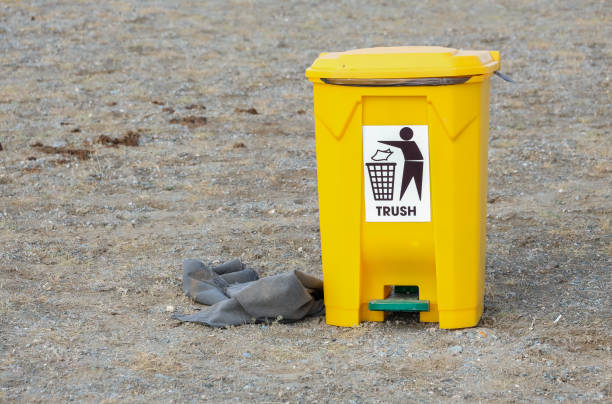 Rubbish bin in Kazakh area of the Altai Mountains Bright yellow rubbish pedal bin, in the Kazakh region of the Altai Mountains. It is located in a public area, with a recognised illustration & text for people to understand that they should put their rubbish in this available container. pedal bin stock pictures, royalty-free photos & images