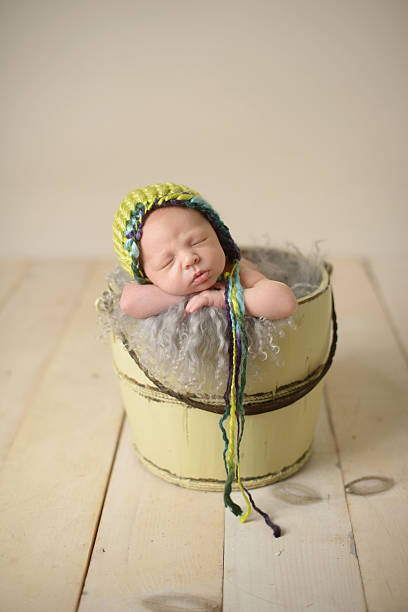 istock Newborn Sleeping in a Bucket 176401431