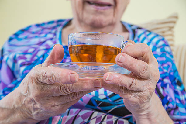 istock holding a glass of tea 176403337
