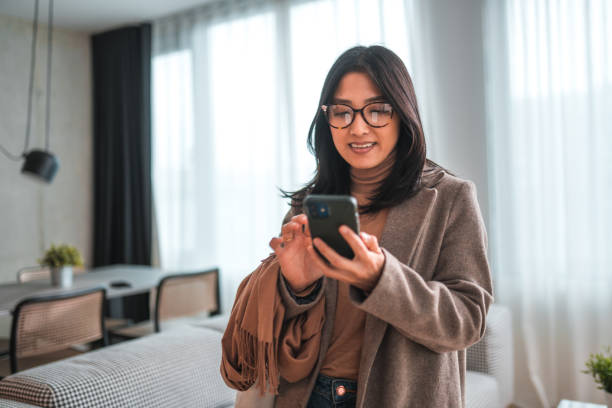 istock Beautiful Young Hispanic Woman Standing And Scrolling Through Phone 1764036695