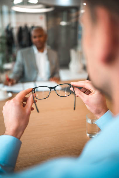 istock Caucasian Businessman Holding Eyeglasses In A Modern Office 1764040603