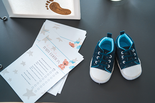 Illustration and baby shoes on a paper with lines for filling in. Perfect for a baby shower activity or keepsake.