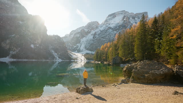 Woman  standing on the background of  Lago di Braies in winter