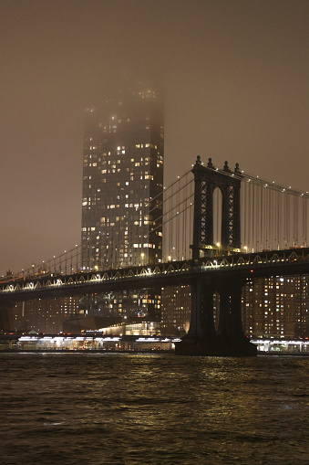 Manhattan Bridge vertical image. Photo taken on a foggy night in early December.