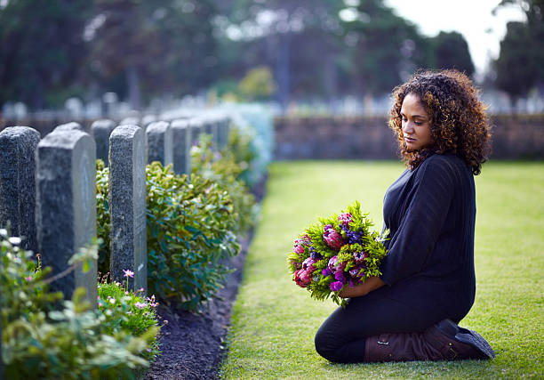 Paying her respects  cemetery stock pictures, royalty-free photos & images