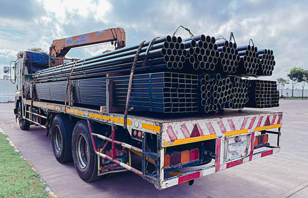 istock Trucks with long trailers carrying steel bars for building construction. Construction steel is ready to be delivered to the customer. 1764074383