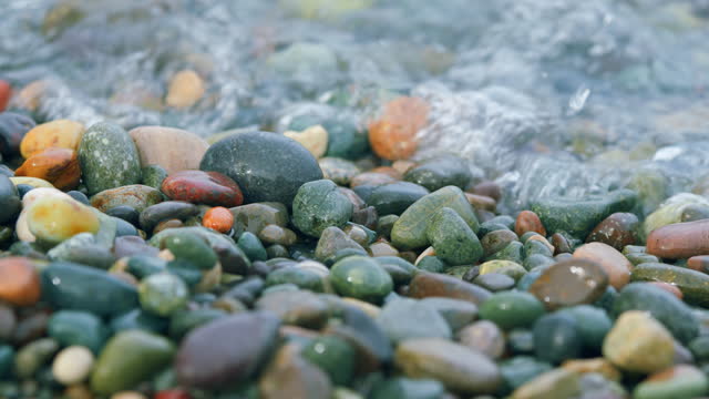 Colorful Sea Pebbles. Small Sea Foam Waves Breaking On A Pebble Beach. Bokeh.