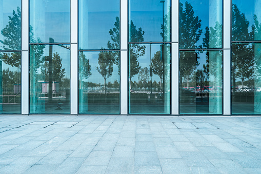 Closeup modern office building glass wall with reflection, abstract background with copy space, full frame horizontal composition