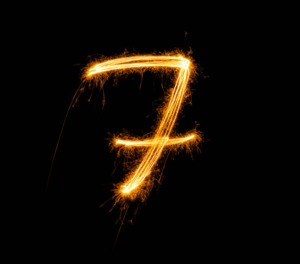 istock Fireworks numbers 7 Burning sparkler Numbers isolated on black background. Sparkler firework light alphabet 7 and number seven. Numbers Alphabet of Sparklers 1764117285