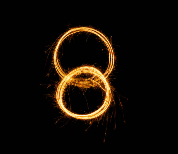 istock Fireworks numbers 8 Burning sparkler Numbers isolated on black background. Sparkler firework light alphabet 8 and number eight. Numbers Alphabet of Sparklers 1764117288