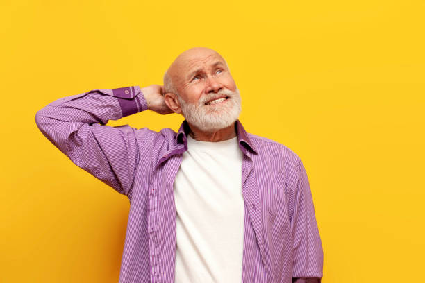 istock puzzled old bald grandfather with gray beard thinks and remembers on yellow isolated background 1764145611