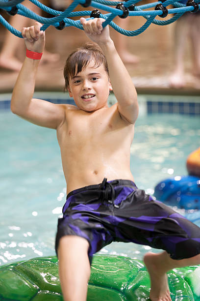 istock Young boy playing at the indoor water park 176414695