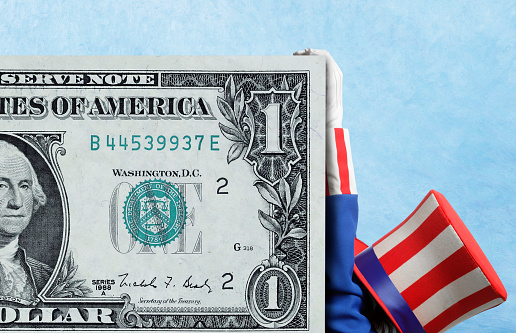 Dollar banknotes and flag of the USA