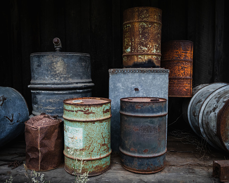 Old rusty containers used for oil and fuel storage.