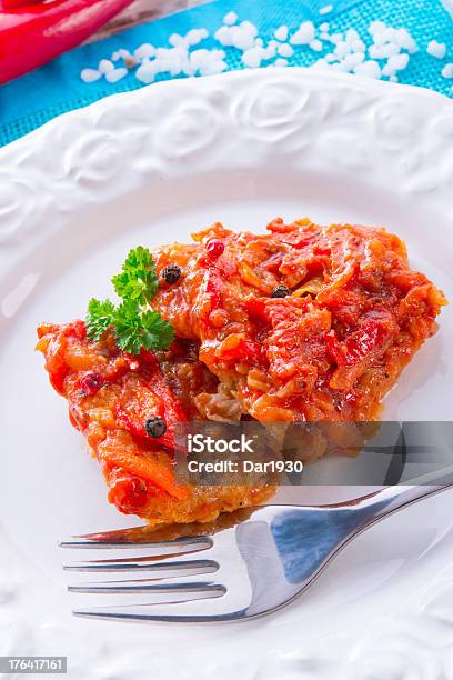 Fish In Greek Kind With Vegetables And Tomato Sauce Stock Photo - Download Image Now