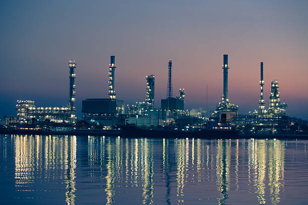 Petroleum oil refinery beside the river at sunrise