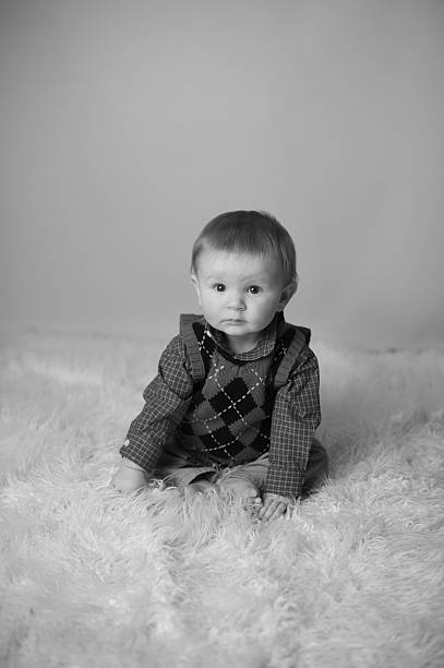 istock Black and White Serious Baby Sitting on Fur 176419150