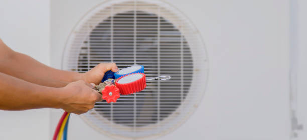 istock Air conditioning, HVAC service technician using gauges to check refrigerant and add refrigerant. 1764192173