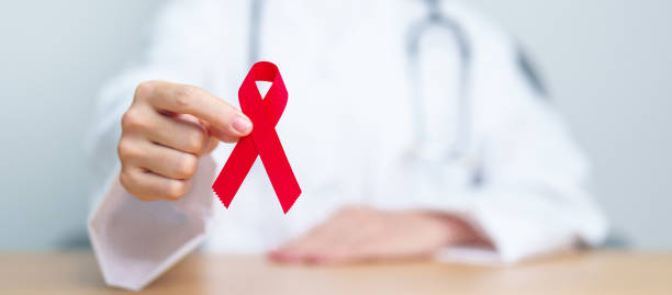 Doctor with Red Ribbon for December World Aids Day, acquired immune deficiency syndrome, multiple myeloma Cancer Awareness month and National Red ribbon week. Healthcare and world cancer day concept Doctor with Red Ribbon for December World Aids Day, acquired immune deficiency syndrome, multiple myeloma Cancer Awareness month and National Red ribbon week. Healthcare and world cancer day concept aids walk stock pictures, royalty-free photos & images