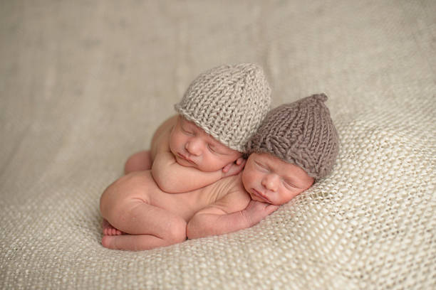 istock Newborn Twins Sleeping in Knit Hats 176421860