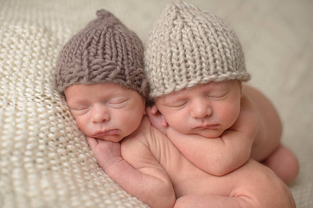istock Newborn Twins Sleeping in Knit Hats 176421863