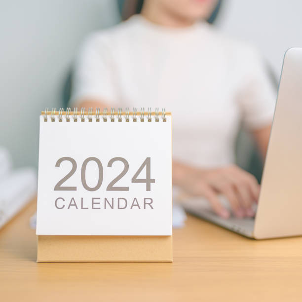 istock 2024 Year Calendar on table with business woman using laptop computer. countdown, Happy New Year, Resolution, Goals, Plan,  Action, Mission and financial Concept 1764219125