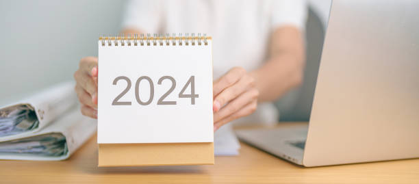 istock 2024 Year Calendar on table with business woman using laptop computer. countdown, Happy New Year, Resolution, Goals, Plan,  Action, Mission and financial Concept 1764219129