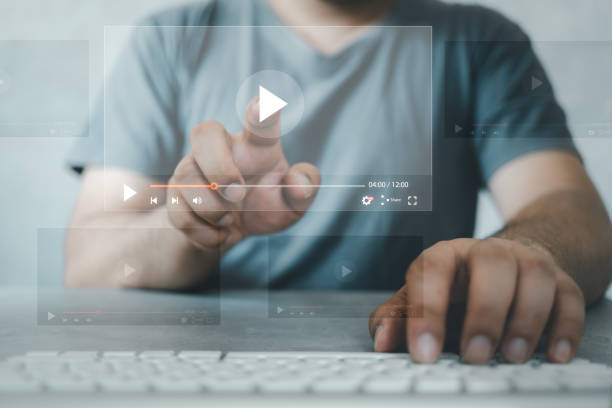 istock Man touching play icon video online on a virtual display. Online content concept 1764230885