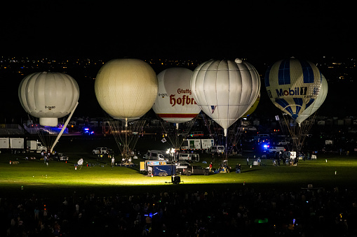Albuquerque, New Mexico - USA - Oct 7, 2023: Gas balloons preparing to launch after sunset for the 66th Coupe Aeronautique Gordon Bennett balloon race at the Albuquerque International Balloon Fiesta.