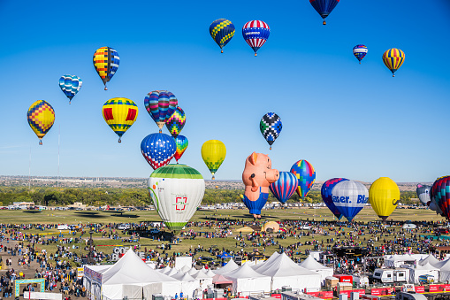 Albuquerque, New Mexico - USA - Oct 13, 2023: Several hot air balloons fly over the field at the Albuquerque International Balloon Fiesta